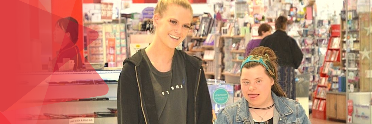 Two people shopping and laughing.