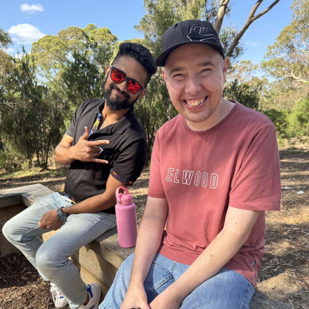 Y support worker sitting and smiling with a participant