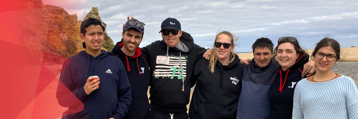 Adult campers smiling on a beach