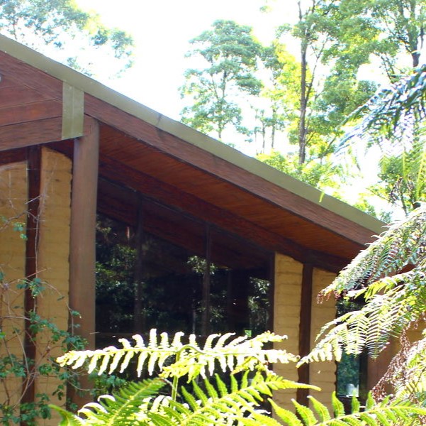 mudbrick building in ferny bush setting