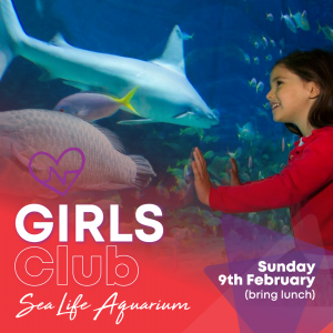 Girls looking at aquarium window